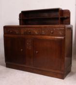 A 1930's Art Deco oak sideboard having cupboards and drawers with an upright gallery sectional back.
