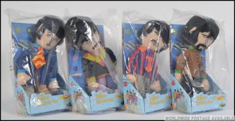 A collection of four Beatles plush figures by Factory, in original packaging to include Paul, John,