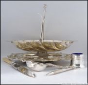 A collection of silver plate to include a rococo dish, bon bon basket,