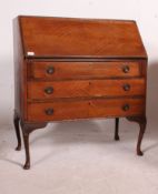 A 20th century Queen Anne style bureau, having quarter veneer finish,