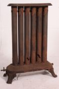 An early 20th century large cast iron architectural radiator with plinth base,