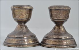 A pair of silver hallmarked stub candlesticks. Hallmarks for Broadway and Co, Birmingham 1971.