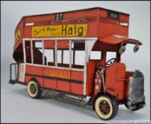 A good sized tinplate model of a vintage red bus.