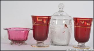 A Mary Gregory clear glass and cameo painted biscuit barrel together with a collection of cranberry