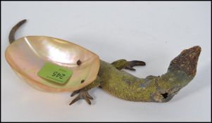 A stunning early 20th Century cast metal cold painted model of a lizard,