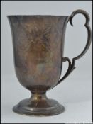 An early Victorian silver hallmarked ladies goblet / vessel having scrolled handle with rococo