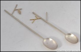 A pair of Scottish contemporary silver hallmarked teaspoons having twig and leaf design.
