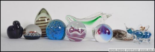 A collection of glass paperweights from the 20th century to include a Mdina, Millefiori,