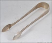 A good sized pair of silver hallmarked sugar tongs by Richard Poulden London 1821. Total weight 45.