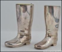 A silver plated pair of spirit measures in the form of riding boots complete with the liners.