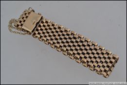 A 9ct gold mesh link bracelet with clip clasp and safety chain. Maker C & F.