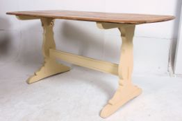 A 20th century vintage Ercol refectory dining table having wax polished top raised over shabby chic