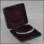 A hallmarked 18ct gold and diamond bracelet bangle with approx 150pts of cushion cut diamonds in a