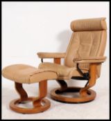 A vintage 20th century Ekornes ' Stressless ' reclining swivel armchair raised on bentwood base
