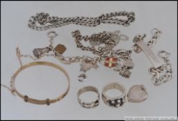 A collection of silver and silver metal items of jewellery to include bracelets, charm bracelet,
