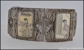 A beautiful early 20th century silver filigree and bone cartouche panel decorated ladies bracelet.