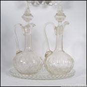 A matching pair of cut glass early 20th century claret jugs,