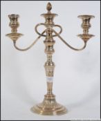 A 20th century silver plated three sconce candle stick. Measures: 41cm H.