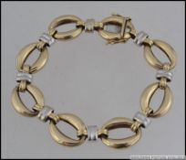 A hallmarked Chiampesan Italian designer 9ct gold bracelet with oval and bar links in white and