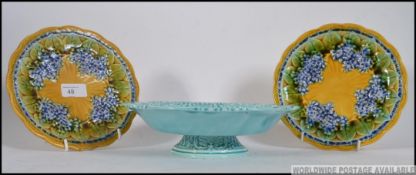 2 Majolica ceramic glazed plates together with a blue glazed tazza by Villeroy & Boch,