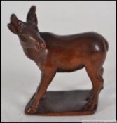 A Chinese hardwood carved figure of a dear , signed to base .