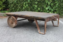 A vintage industrial early 20th century Bogie trolley having cast iron wheels with iron angular