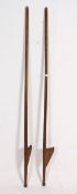 An unusual pair of 1930's fairground / fete show wooden stilts having shaped handles atop.