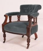 An Edwardian mahogany salon armchair having a carved show wood frame being upholstered in a blue