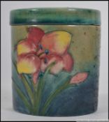 A Moorcroft cylindrical lidded pot of Hibiscus pattern,