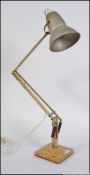 An early 20th century Herbert Terry scrumble finish anglepoise desk lamp raised on twin step base