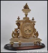 A Victorian alabaster mantel clock with gilded finials inset brass movement striking on a bell ( af