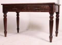 An early 20th century Air Ministry oak writing table desk being raised on squared legs with fitted