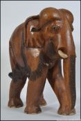 A good quality large hardwood carved sculpture of an elephant. ( see illustrations ).