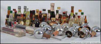 A collection of vintage miniatures along with vintage mid century chrome drink pourers etc