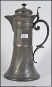 A large 20th century pewter tankard jug with lid having scrolled handle.