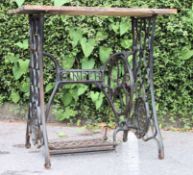 A vintage garden table being constructed from an upcycled Singer sewing machine treadle base with