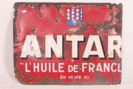 A large early 20th century French enamel advertising sign for Antar having red ground with notation.