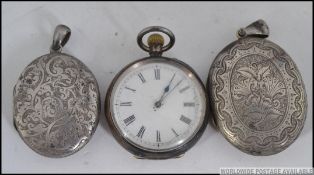 2 white metal rococo ladies pendant chain lockets each being rococo chased with black and white