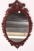 A good quality 20th century ornately carved wall hanging mirror,