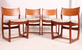 A set of 4 retro Danish influence teak dining chairs having sleigh end sides united by stretchers