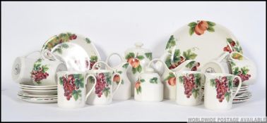 A Royal Doulton ' Vintage Grape ' pattern tea service comprising the teapot, cups,