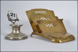 A silver plate capstan inkwell with calendar atop together with a metamorphic brass stationary