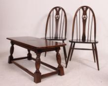 2 Ercol beech and elm quaker style dining chairs together with an oak refectory style coffee table.
