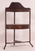 A 19th century Georgian mahogany corner washstand having three tiers,