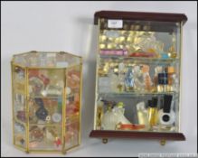 A collection of perfumes and bottles all displayed across two display cabinets.