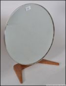 A retro 1970's teak wood dressing table / vanity circular mirror raised on a single pedestal stand