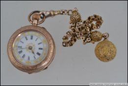 A 9ct gold ladies fob watch with decorative face being set on a stunning 9ct chain and ball finial.
