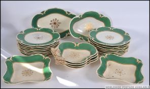 A 19th century Rockingham china dinner service having green banded borders with gilt finish having