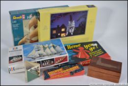 A boxed unused model of the Mayflower along with a model of Esmerelda, boxed board game,