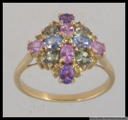A hallmarked 9ct gold dress ring with oval cut multi pastel shade tourmaline in a marquise cluster